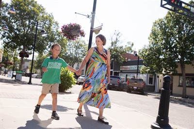 Mom and son walking together downtown